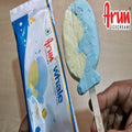 Ice cream bar shaped like a whale with Arun Icecreams packaging on a wooden surface