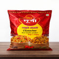 Red package of Chanachur on a wooden surface with a white background
