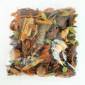 Assorted dried herbs and spices on a white background