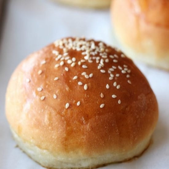 Sesame seed bun on a white surface