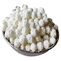 Bowl of white cauliflower florets on a white background